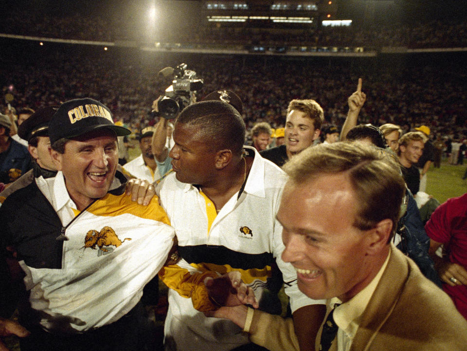 FILE - Colorado coach Bill McCartney, left, is escorted off the Orange Bowl field after the Buffaloes defeated Notre Dame, 10-9, in the 57th annual Orange Bowl Classic, in Miami, Jan. 1, 1991. By removing a potential stumbling block, Colorado has a chance to consistently win, just like in the days of Bill McCartney when the Buffaloes won their only national title.(AP Photo/Ray Fairall, File)