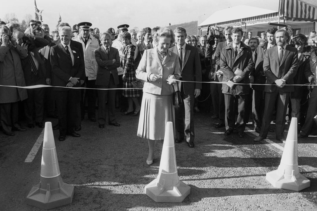 The Prime Minister Mrs Margaret Thatcher cuts the ribbon to open the final section of the M25 motorway.   (Photo by PA Images via Getty Images)