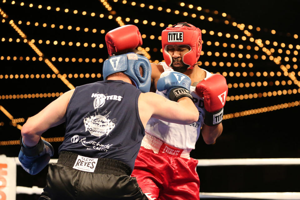 <p>NYPD officer known as “Spiderman” feels the punch of opponent Mike Alba during the NYPD Boxing Championships at the Theater at Madison Square Garden on June 8, 2017. (Gordon Donovan/Yahoo News) </p>