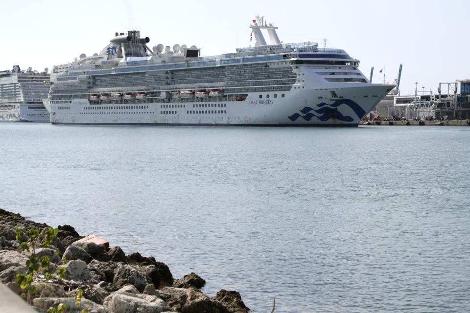 The Coral Princess cruise ship arrives at PortMiami during the new coronavirus outbreak, Saturday, April 4, 2020, in Miami. According to Princess Cruises, disembarkation of guests is expected to take several days due to limited flight availability. Guests requiring shoreside medical care will be prioritized to disembark first. (AP Photo/Lynne Sladky)