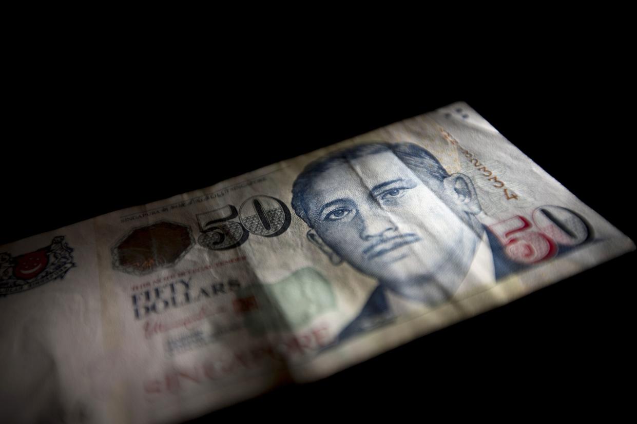 The image of Yusof Ishak, former president of Singapore, is displayed on a Singapore fifty dollar banknote in an arranged photograph in Bangkok, Thailand, on Friday, Sept. 18, 2015.  Photographer: Brent Lewin/Bloomberg