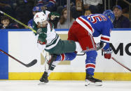 New York Rangers' Julien Gauthier (15) checks Minnesota Wild's Brandon Duhaime (21) during the first period of an NHL hockey game Friday, Jan. 28, 2022, in New York. (AP Photo/John Munson)