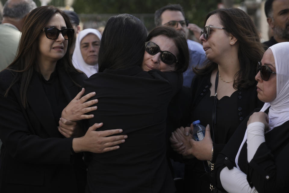 Family, friends and colleagues of slain Al Jazeera journalist Shireen Abu Akleh comfort each other in the east Jerusalem neighbourhood of Sheikh Jarrah, Thursday, May 12, 2022. Abu Akleh, a Palestinian-American reporter who covered the Mideast conflict for more than 25 years, was shot dead Wednesday during an Israeli military raid in the West Bank town of Jenin. (AP Photo/Mahmoud Illean)
