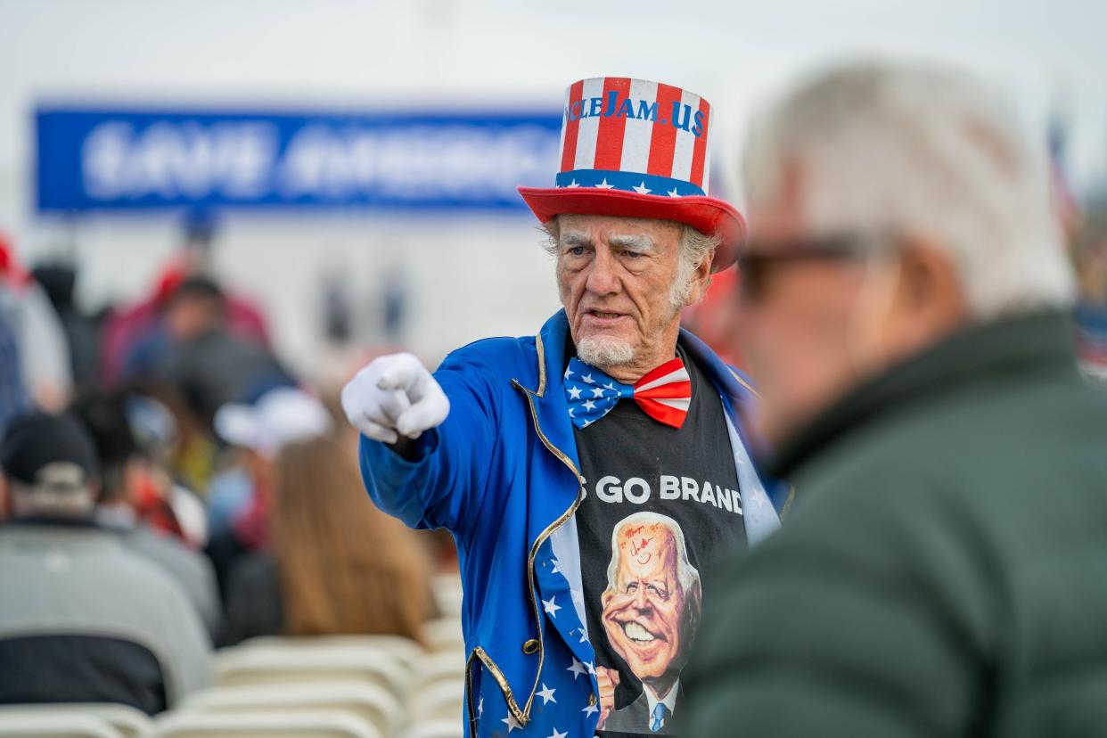 Duane Schwingel points to a crowd member at former President Donald Trump's Save America Rally in Florence, Ariz. on Saturday, Jan. 15, 2022.