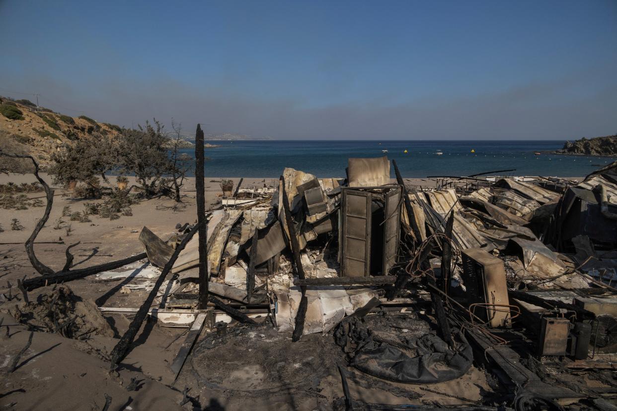 A destroyed beach bar at the beach of Glystra, as a wildfire burns on the island of Rhodes (REUTERS)