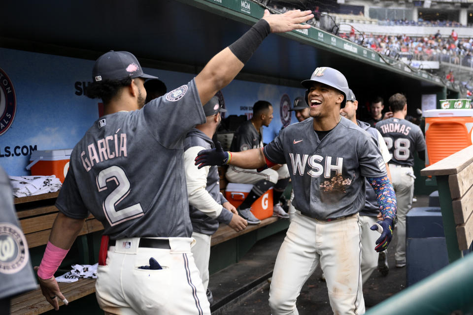 Washington Nationals' Juan Soto, right, celebrates his two-run home run with Luis Garcia (2) during the fifth inning of a baseball game against the Milwaukee Brewers, Saturday, June 11, 2022, in Washington. (AP Photo/Nick Wass)