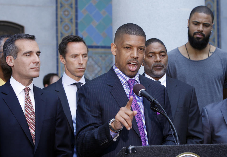 In this photo taken on April 29, 2014, Sacramento, Calif., Mayor Kevin Johnson, at podium, with Los Angeles Mayor Eric Garcetti, left, speaks about the penalties imposed on Los Angeles Clippers owner Donald Sterling by the NBA at a news conference at Los Angeles City Hall. From second left are current and former NBA players Steve Nash, Norm Nixon and Tyson Chandler. Last year Johnson almost single-handedly kept the Kings NBA franchise in Sacramento, staging a late-game comeback to snatch the team away from a Seattle billionaire. This spring he began raising his national political profile by taking over as the head of the U.S. Conference of Mayors, then acting as spokesman for the NBA players as the controversy over racist remarks by the Clippers' owner threatened to throw the basketball league into turmoil. (AP Photo/Nick Ut)