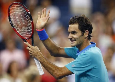 Roger Federer of Switzerland celebrates after defeating Marcel Granollers of Spain in the men's singles play following their match at the 2014 U.S. Open tennis tournament in New York, August 31, 2014. REUTERS/Adam Hunger