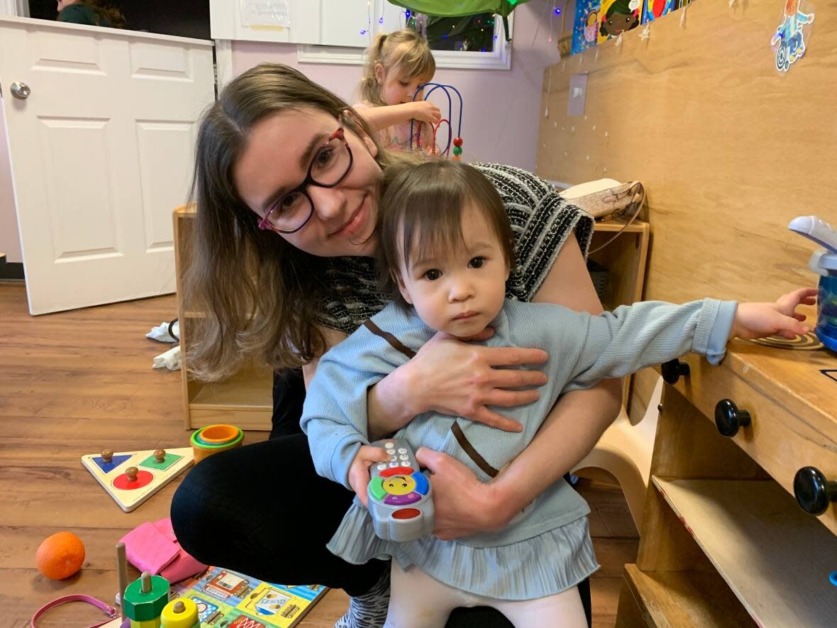 Sarah Chow hugs her 15-month-old daughter, Mira, during play at Health Park Early Learning Centre in Sydney, N.S. (Shaina Luck/CBC - image credit)