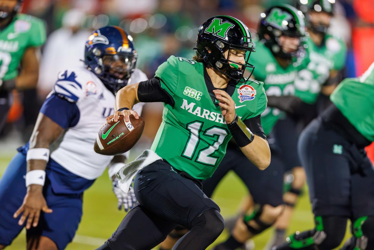 Dec 19, 2023; Frisco, TX, USA; Marshall Thundering Herd quarterback Cole Pennington (12) runs with the ball during the first quarter against the UTSA Roadrunners at Toyota Stadium. Mandatory Credit: Andrew Dieb-USA TODAY Sports