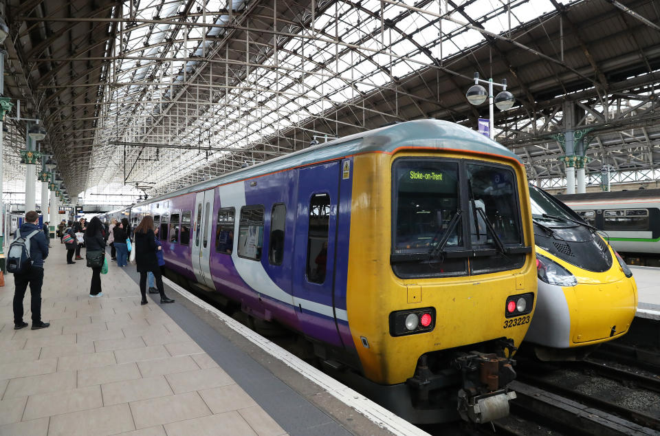 MANCHESTER, ENGLAND - MARCH 19:   Passengers wait to board a train at Manchester Piccadilly station after it's announced that rail cancellations will start tomorrow, with reduced timetables predicted for next week as the UK adjusts to life under the Coronavirus pandemic on March 19, 2020 in Manchester, England.  (Photo by Alex Livesey - Danehouse/Getty Images)