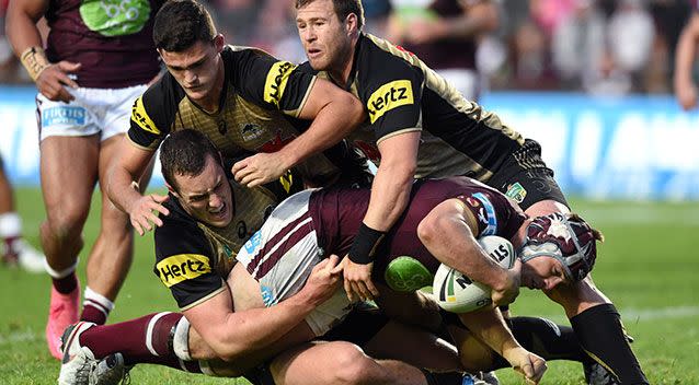 Jamie Buhrer (right) of the Sea Eagles is tackled by Isaah Yeo (left), Nathan Cleary (centre) and Trent Merrin. Source: AAP Image/Paul Miller