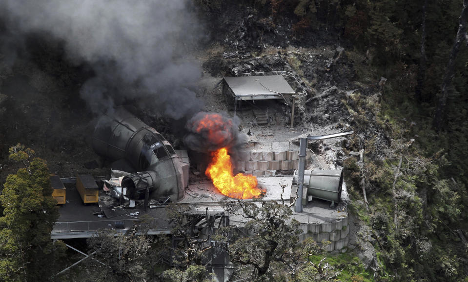 FILE - Flames burn from a ventilation shaft above the Pike River mine on Nov. 30, 2010, where 29 miners are fatally trapped, in Greymouth, New Zealand. More than a decade after a methane explosion killed 29 workers at the New Zealand coal mine, police said on Wednesday, Nov. 17, 2021, they have finally found at least two of the bodies thanks to new camera images. (Iain McGregor/NZPA via AP, File)