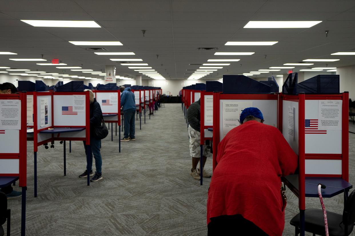 Voters cast their ballot in the 2022 midterm election during early voting at the Hamilton County Board of Elections in Norwood