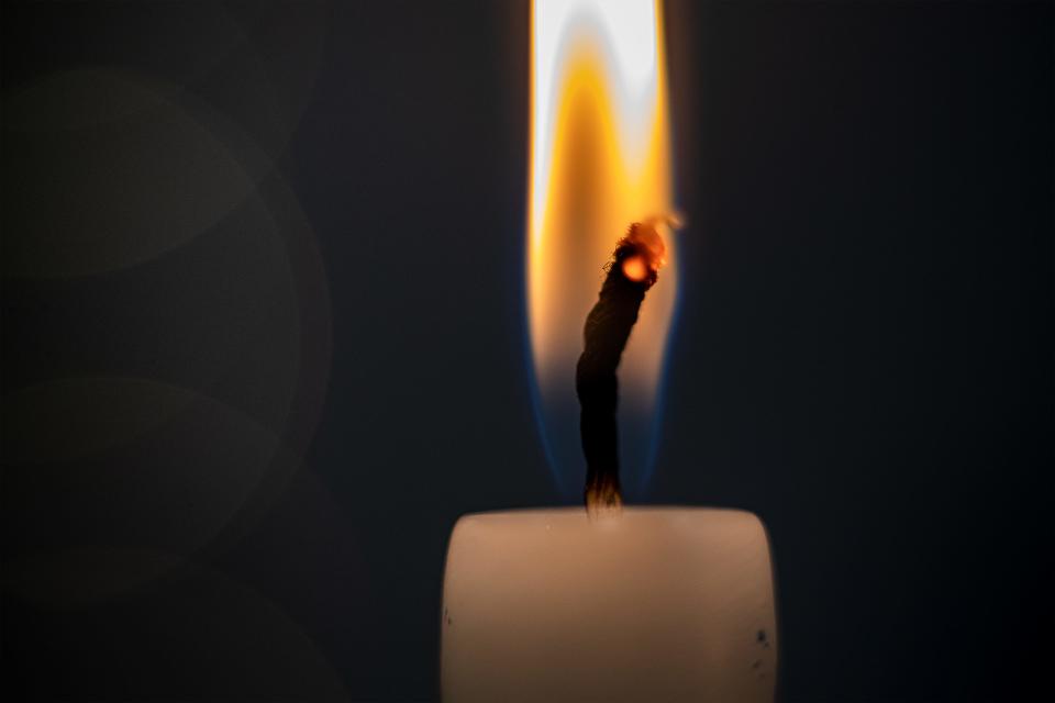 A menorah candle burned bright during a Hanukkah celebration at the Trager Family Jewish Community Center on Monday, Dec. 19, 2022.