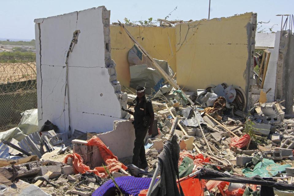 A Somali soldier walks in the debris of a destroyed building near the scene of a suicide car bomb attack in Mogadishu, Somalia, Monday, Jan. 2, 2017. A suicide bomber detonated an explosives-laden vehicle at a security checkpoint near Mogadishu's international airport Monday, killing at least three people, a Somali police officer said. (AP Photo/Farah Abdi Warsameh)