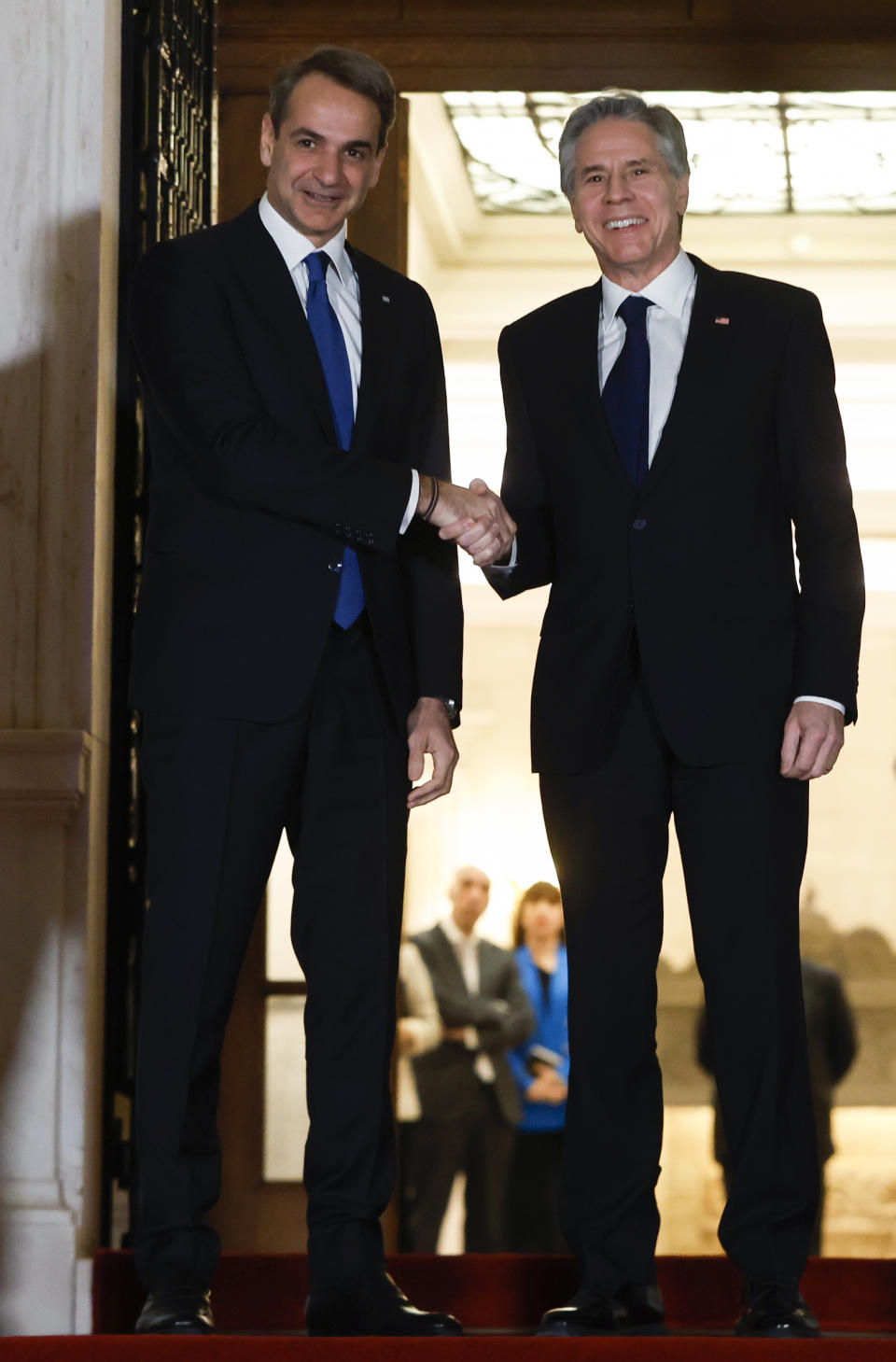 Greece's Prime Minister Kyriakos Mitsotakis, left, welcomes the US Secretary of State Antony Blinken before their meeting at Maximos Mansion in Athens, Greece, on Monday, Feb. 20, 2023. Blinken will be on a two-day trip in Athens, after his visit to Turkey, to meet with the country's leadership and launch the fourth round of the US-Greece Strategic Dialogue. (Louiza Vradi/Pool Photo via AP)