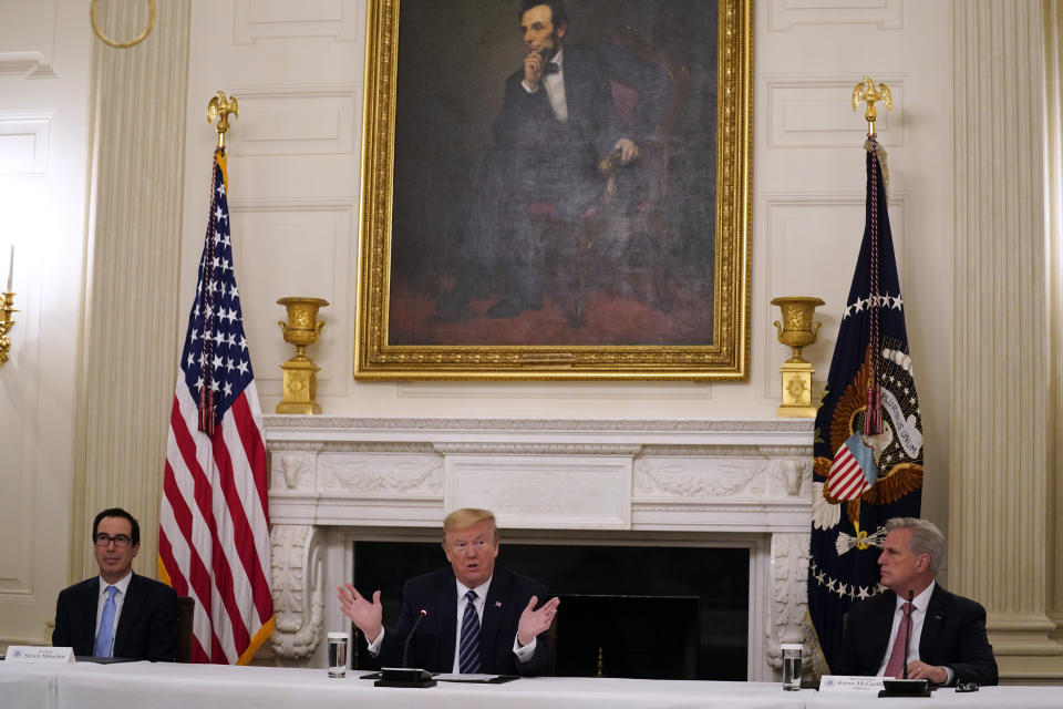 House Minority Leader Kevin McCarthy of Calif., right, and Treasury Secretary Steven Mnuchin, left, listen as President Donald Trump speaks during a meeting with Republican lawmakers, in the State Dining Room of the White House, Friday, May 8, 2020, in Washington. (AP Photo/Evan Vucci)