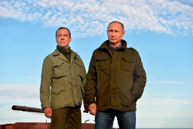 FILE PHOTO: Russian President Putin and Prime Minister Medvedev are seen during their meeting at Lipno Island in Novgorod region