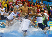 Britain's Tom Daley (C) is thrown into the pool by the British diving team after he won the bronze medal in the men's 10m platform final at the London 2012 Olympic Games at the Aquatics Centre August 11, 2012. REUTERS/Michael Dalder (BRITAIN - Tags: SPORT DIVING OLYMPICS TPX IMAGES OF THE DAY) 