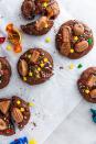 <p>These cookies would work brilliantly with any selection box of chocs. We recommend keeping the cream-centred chocs, caramels and toffee pennies for tucking inside the cookie dough (otherwise they ooze everywhere and make a bit of a mess).</p><p>Get the <a href="https://www.delish.com/uk/cooking/recipes/a29317195/quality-street-cookies/" rel="nofollow noopener" target="_blank" data-ylk="slk:Quality Street Cookies;elm:context_link;itc:0;sec:content-canvas" class="link ">Quality Street Cookies</a> recipe</p>