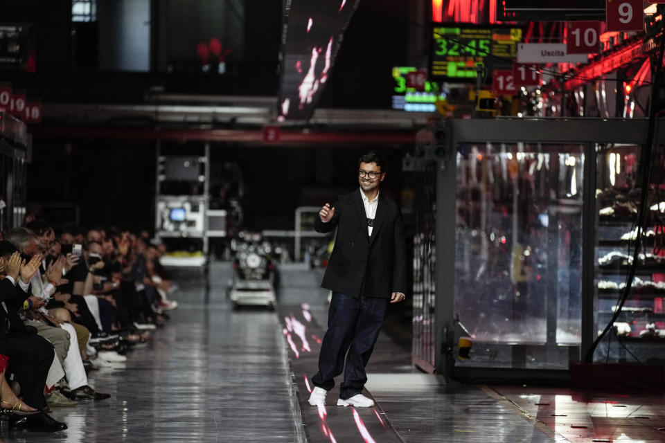 Designer Rocco Iannone accepts applause at the conclusion of the Ferrari women's and men's Spring Summer 2022 collection, in Maranello, Italy, Sunday, June 13, 2021. (AP Photo/Antonio Calanni)