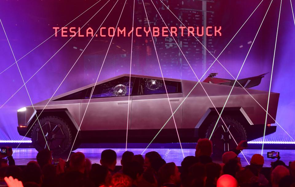 People take pictures of the newly unveiled all-electric battery-powered Tesla's Cybertruck with shattered windows after a failed resistance test, at Tesla Design Center in Hawthorne, California on November 21, 2019. (Photo by FREDERIC J. BROWN / AFP) (Photo by FREDERIC J. BROWN/AFP via Getty Images)