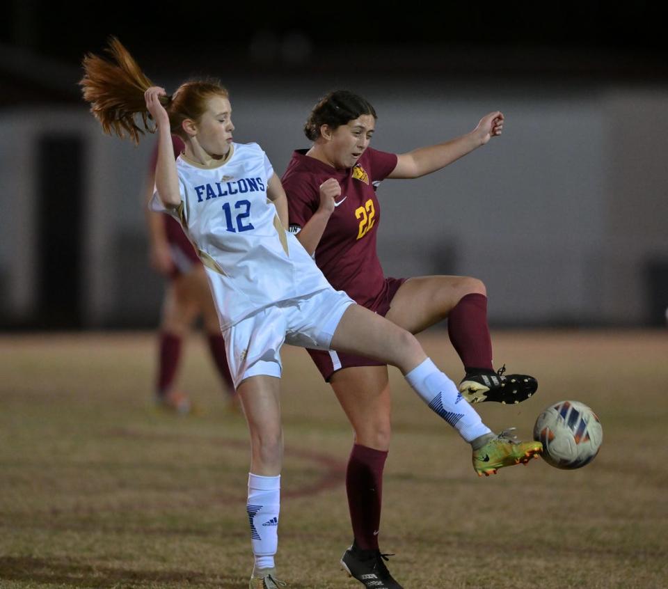 Menendez's Alayna Dial (12) and St. Augustine's Kelsey Maxwell (22) battle for the ball during Friday's District 3-5A semifinal.