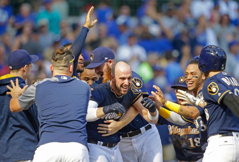 Milwaukee Brewers' Travis Shaw, center, is congratulated by teammates after a two-run game winning homer against the Chicago Cubs in the 10th inning on Saturday, Sept. 23, 2017, in Milwaukee. The Brewers won 4-3 in 10 innings.