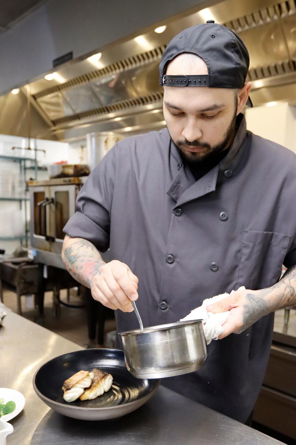 Executive Chef of the Drayton Hotel Benjamin Murray plates their Snapper and Grits at the St. Neo's Brasserie in the Drayton Hotel in Savannah, GA Saturday, May 28, 2022.