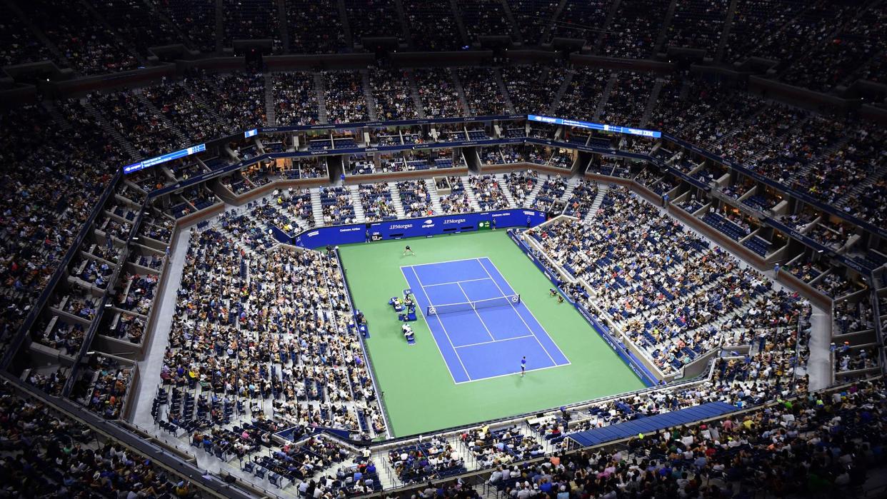 TOPSHOT - An overview shows Arthur Ashe Stadium during the 2021 US Open Tennis tournament men's singles first round match between Serbia's Novak Djokovic (bottom) and Denmark's Holger Rune at the USTA Billie Jean King National Tennis Center in New York, on August 31, 2021.