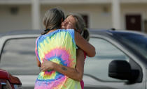 Nancy Register, right, weeps as she is comforted by Roxie Cline, after she lost her home and all the contents inside to Hurricane Michael in Mexico Beach, Fla., Wednesday, Oct. 17, 2018. Register said she doesn't know how she and her husband will make it through this, saying they only have money to last them four more days. (AP Photo/Gerald Herbert)