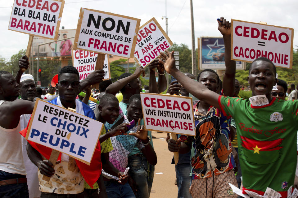 FILE - Supporters of Capt. Ibrahim Traore protest against France and the West African regional bloc known as ECOWAS in the streets of Ouagadougou, Burkina Faso, Tuesday, Oct. 4, 2022. French President Emmanuel Macron is to unveil on Monday Feb.27, 2023 his country's changing economic and military strategy in Africa in the coming years, as France's influence substantially declines on the continent. Macron is expected to call for a more balanced partnership with African nations, in a speech before he begins Wednesday an ambitious African trip to Gabon, Angola, the Republic of Congo and Congo. (AP Photo/Kilaye Bationo, File)