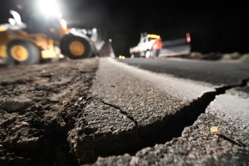 Highway workers repair cracks in a roadway as a result of the July 5, 2019 earthquake, in Ridgecrest, California, about 150 miles (240 km) north of Los Angeles