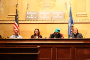 Panelists at a day of action to call for an end to solitary confinement sit in the Capitol. (Photo | Isiah Holmes)