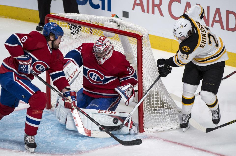 Boston Bruins' Loui Eriksson, right, tries to score past Montreal Canadiens goalie Carey Price on the wrap around as defenseman Douglas Murray comes in during the second period in Game 4 in the second round of the NHL Stanley Cup playoffs Thursday, May 8, 2014, in Montreal. (AP Photo/The Canadian Press, Paul Chiasson)