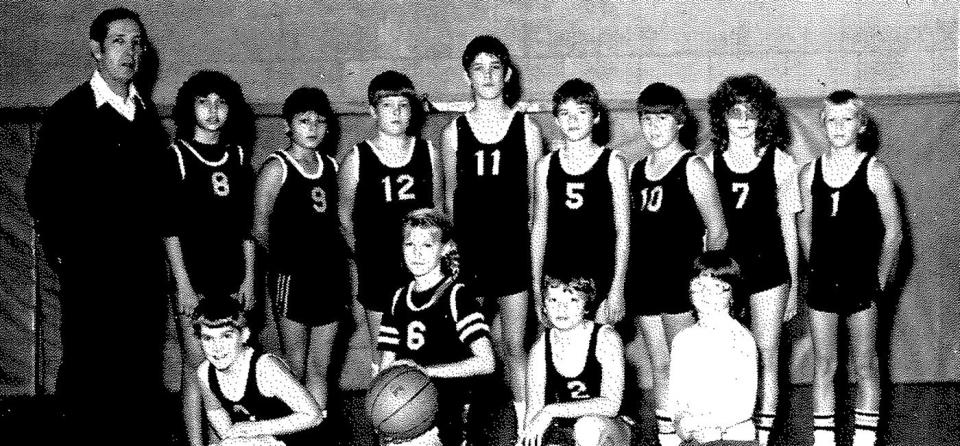 Lisa Wright (second from left, standing) wears No. 8 for the Summitville Elementary sixth-grade boys basketball team.