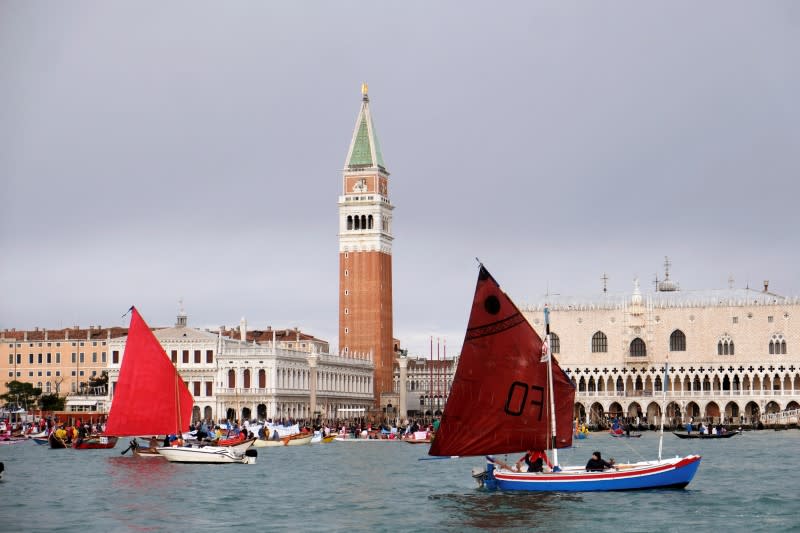 Scores of boats take to the Saint Mark's Basin, as Venetians protest against the damage caused by big ships, in Venice
