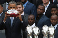 <p>President Barack Obama holds up a football presented to him as a gift by Patriots owner Robert Kraft while Obama welcomed the National Football League Super Bowl champion, the New England Patriots, to the White House April 23, 2015 in Washington, DC. President Obama honored the Super Bowl XLIX champion Patriots who defeated the Seattle Seahawks 33-27 in overtime. (Win McNamee/Getty Images) </p>