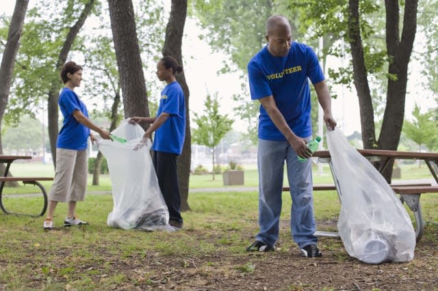 Volunteers picking up trash in park