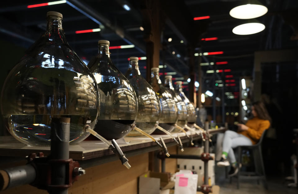 Bottles of brandy in a bar in Belgrade, Serbia, Friday, Nov. 11, 2022. The U.N.'s culture and education organization is set later this month to review Serbia's bid to include "social practices and knowledge related to the preparation and use of the traditional plum spirit - sljivovica" on the list of world intangible cultural heritage. (AP Photo/Darko Vojinovic)