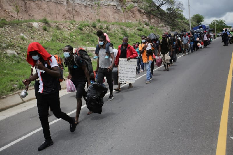 African, Cuban and Haitian migrants, which are stranded in Honduras after borders were closed due to the coronavirus (COVID-19) outbreak, trek northward in an attempt to reach the United States, in Choluteca