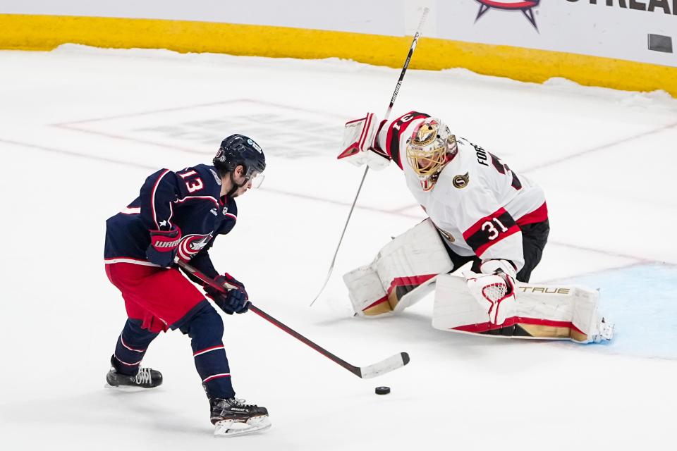 Mar 14, 2024; Columbus, Ohio, USA; Columbus Blue Jackets left wing Johnny Gaudreau (13) shoots at Ottawa Senators goaltender Anton Forsberg (31) during a shootout in the NHL hockey game at Nationwide Arena. The Blue Jackets lost 3-2.