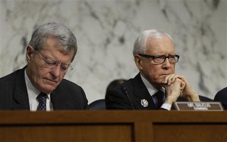 U.S. Senators Max Baucus (D-MT) (L) and Orrin Hatch (R-UT) (R) listen to U.S. Secretary of the Treasury Jack Lew (not pictured) at the Senate Finance Committee on the U.S. government debt limit in Washington October 10, 2013. REUTERS/Gary Cameron