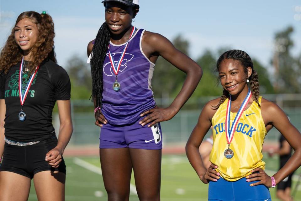 Turlock’s Olivia Walker, right, finished in third place behind St. Mary’s Diyana Hackley, left, and Frankin-EG’s Ihe Okoh, in the 400 m race at the CIF Sac-Joaquin Section Masters track finals at Davis High School in Davis, Calif., Saturday, May 20, 2023.