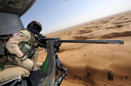 Canadian Forces door gunner Sergeant Chad Zopf leans out of a CH-146 Griffon helicopter during a training exercise in Kandahar district, Afghanistan June 18, 2011 in this handout photo obtained by Reuters March 19, 2018. Sgt Matthew McGregor/Canada Department of National Defence/Handout via REUTERS