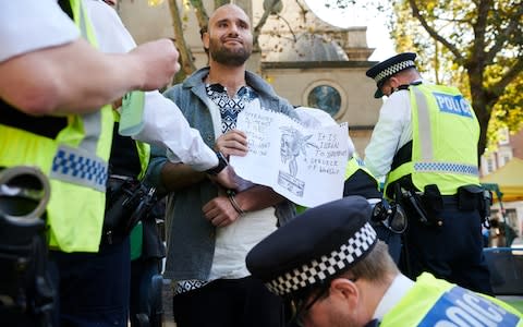 Police arrest a protester after issuing a section 14 notice at an Extinction Rebellion gathering - Credit: Thomas Bowles