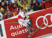 Winner Marcel Hirscher of Austria hits the protection fence as he finishes the second run of men's Slalom event of the Alpine Skiing World Cup downhill ski race in Kitzbuehel January 27, 2013. REUTERS/Leonhard Foeger (AUSTRIA - Tags: SPORT SKIING TPX IMAGES OF THE DAY) - RTR3D1A7