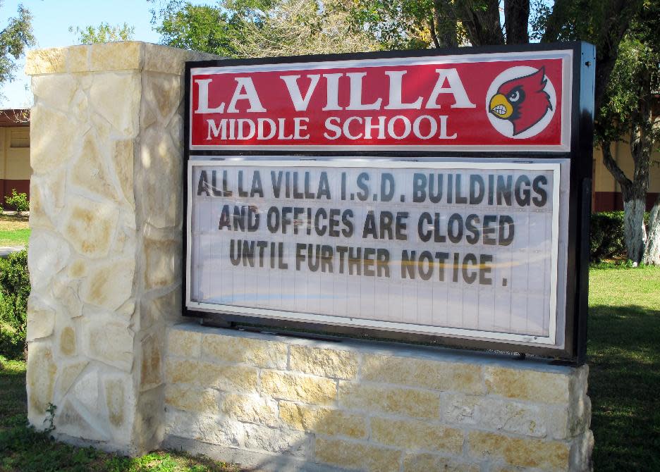 A sign outside La Villa Middle School tells of the school district's status in La Villa, Texas, Monday, Jan. 13, 2014. Schools in La Villa were supposed to return to classes, but instead a water payment dispute with the city has shut the school down. (AP Photo/Chris Sherman)
