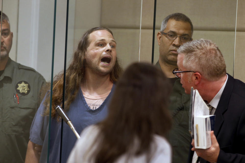 FILE - In this May 30, 2017, fie photo, Jeremy Christian shouts as he is arraigned in Multnomah County Circuit Court in Portland, Ore. Christian, charged with fatally stabbing two men who authorities say confronted him during a racist rant on a Portland, Oregon light-rail train, goes to trial Tuesday, Jan. 21, 2020, two years after the killings that plunged this liberal city into months of soul-searching. (Beth Nakamura/The Oregonian via AP, Pool, File)